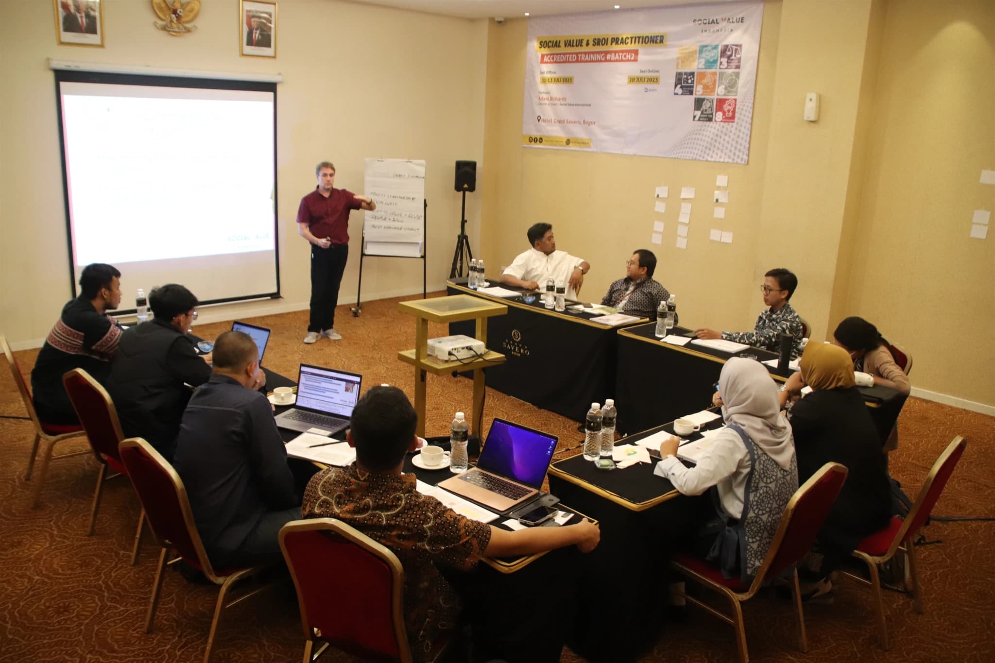 Social impact practitioners collaborating around an impact map